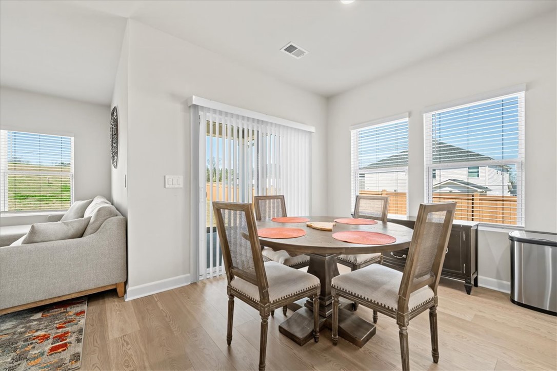 106 Purcell Way Easley, SC 29642 - Photo 10 of 39 This bright and airy dining area offers seamless indoor-outdoor living with a convenient sliding door.