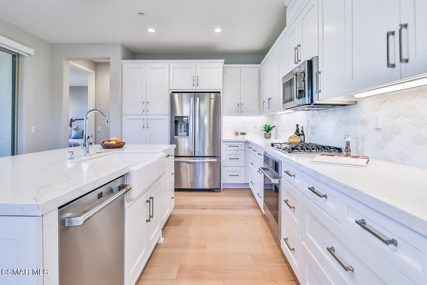 2498 Cherry Tree Drive Camarillo, CA 93012 - Photo 14 of 67 a kitchen with stainless steel appliances a sink stove refrigerator and cabinets