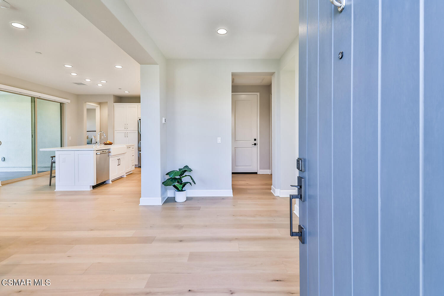 2498 Cherry Tree Drive Camarillo, CA 93012 - Photo 4 of 67 a view of a hallway with wooden floor and kitchen space with a sink