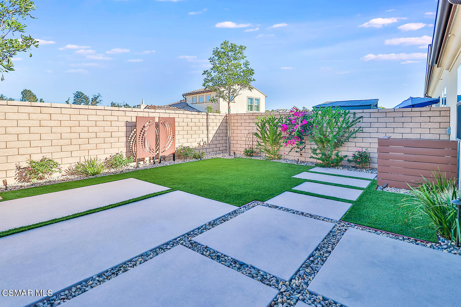 2498 Cherry Tree Drive Camarillo, CA 93012 - Photo 47 of 67 a view of a garden with a building in the background