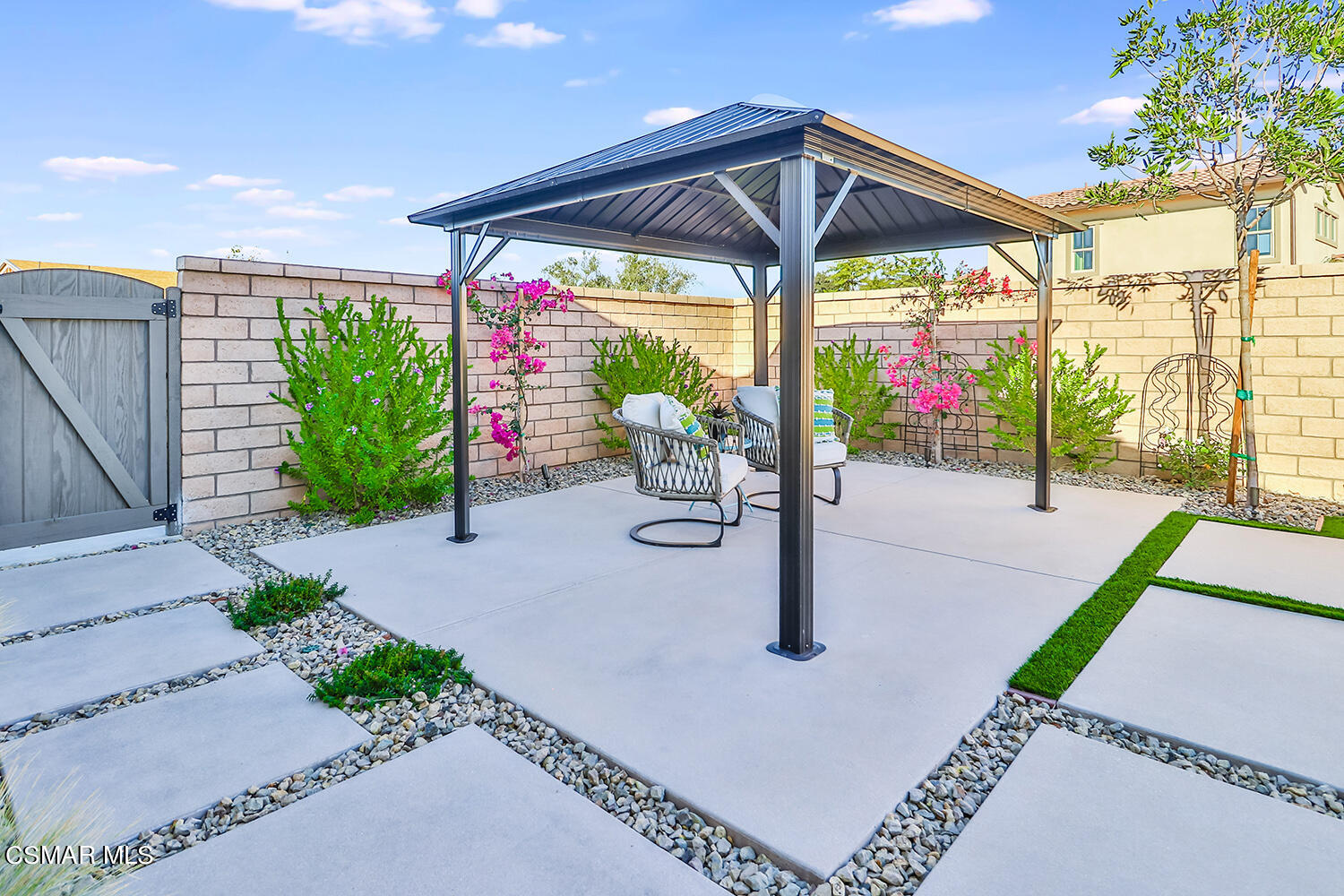 2498 Cherry Tree Drive Camarillo, CA 93012 - Photo 48 of 67 a view of a patio with a table and chairs under an umbrella