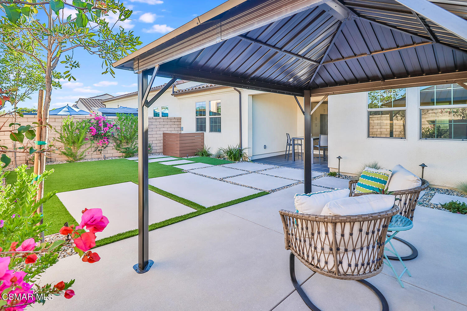 2498 Cherry Tree Drive Camarillo, CA 93012 - Photo 50 of 67 a patio with a table and chairs and potted plants