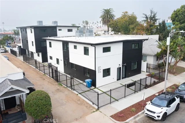 a view of house with roof deck and seating space