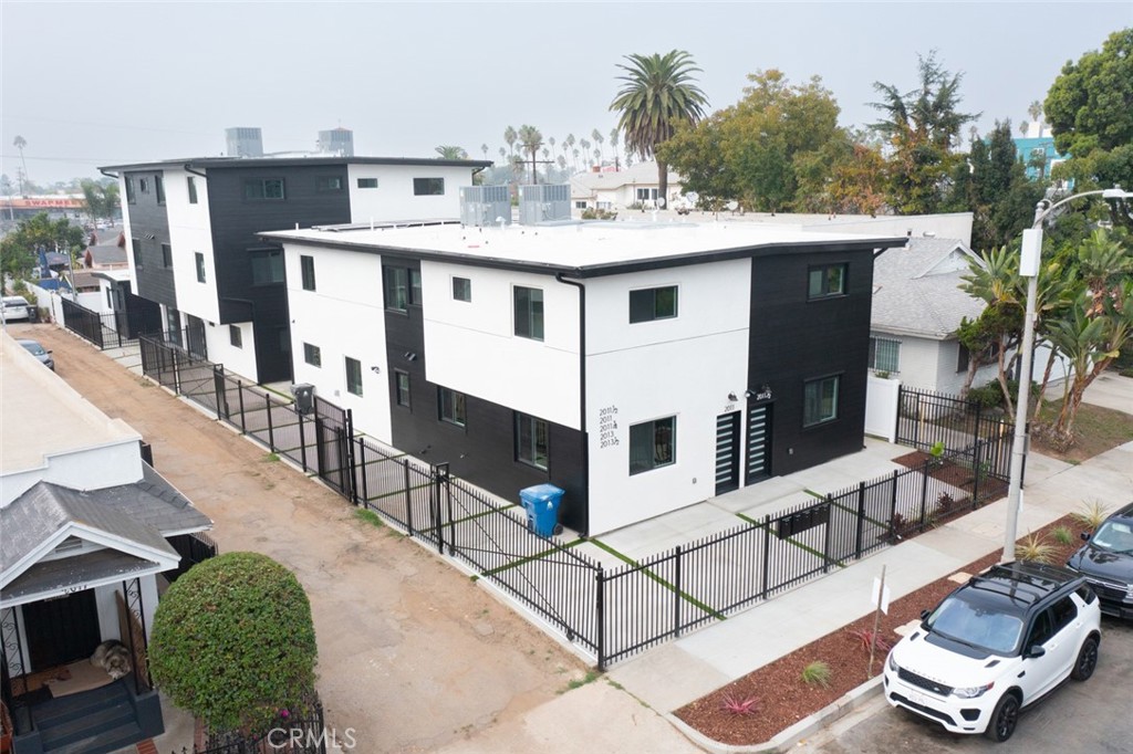 a view of house with roof deck and seating space