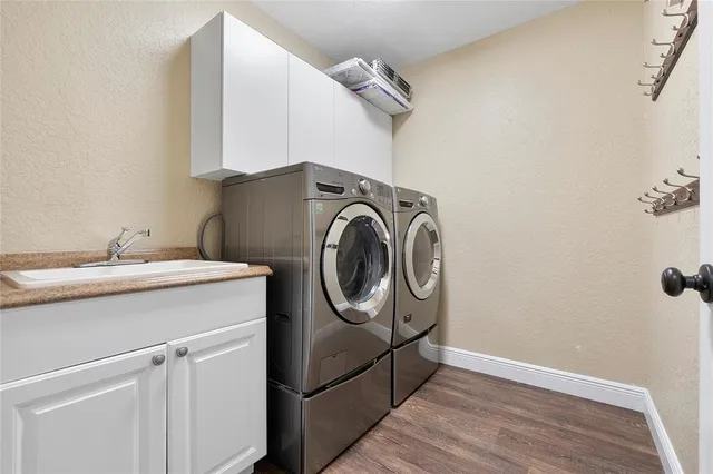 a view of a room with wooden floor and a ceiling fan