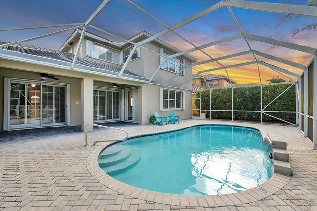 an aerial view of residential houses with outdoor space and trees