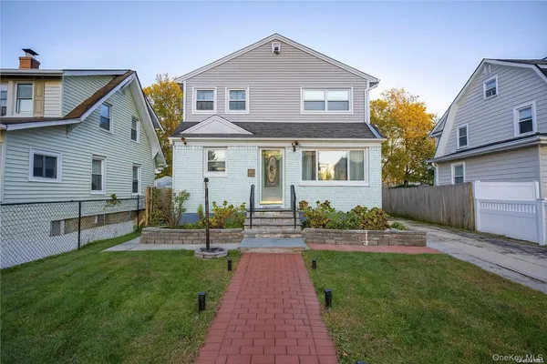 a front view of house with yard and green space