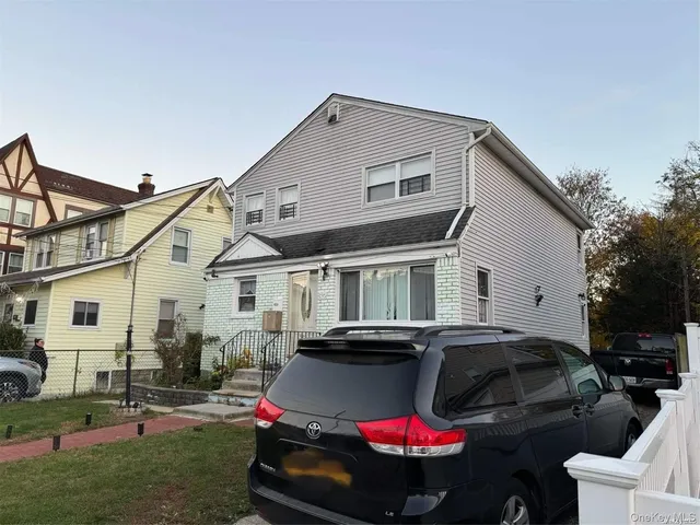 a front view of house with yard and outdoor seating
