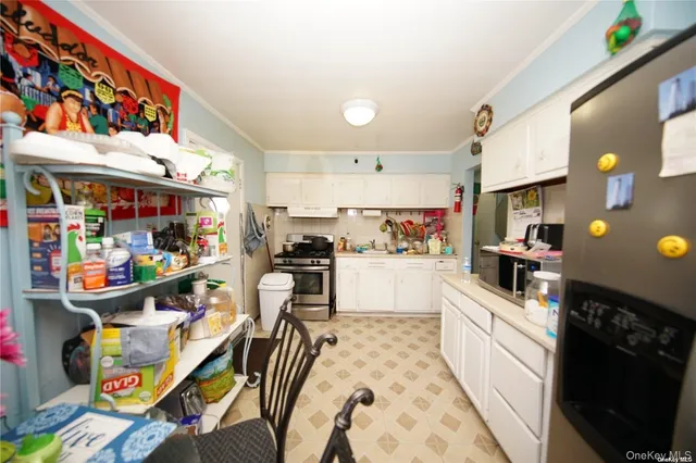 a kitchen filled with stainless steel appliances refrigerator and cabinets