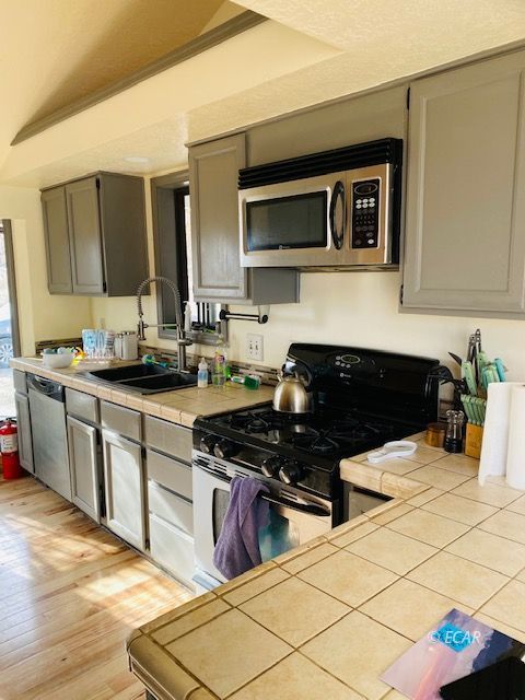 562 Spring Valley Parkway Spring Creek, NV 89815 - Photo 16 of 29 a kitchen with a sink and a stove top oven