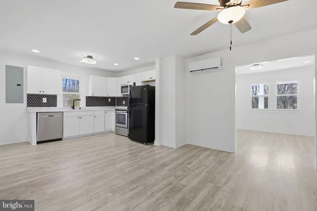 a view of a kitchen with a sink cabinets and stainless steel appliances