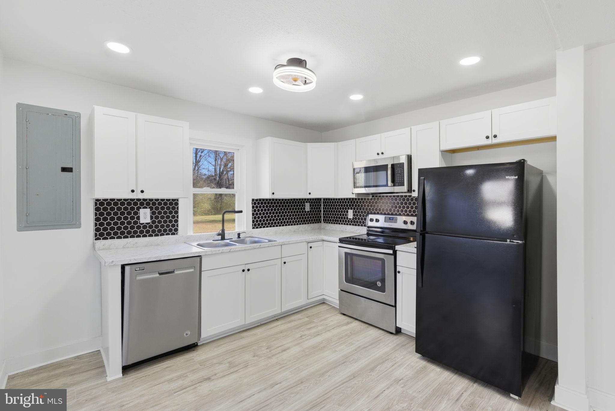 5020 Tucker Hill Road Hague, VA 22469 - Photo 12 of 31 a kitchen with stainless steel appliances granite countertop a refrigerator and a stove top oven