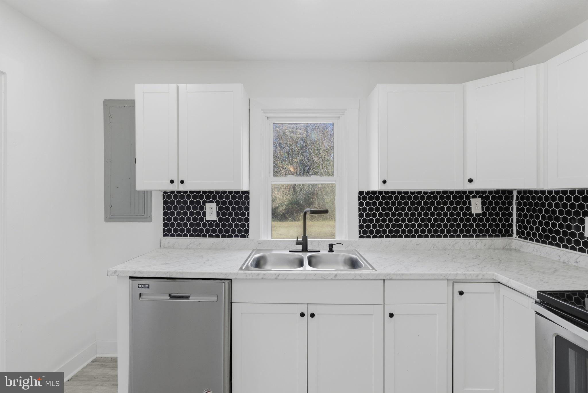 5020 Tucker Hill Road Hague, VA 22469 - Photo 14 of 31 a kitchen with a sink and cabinets