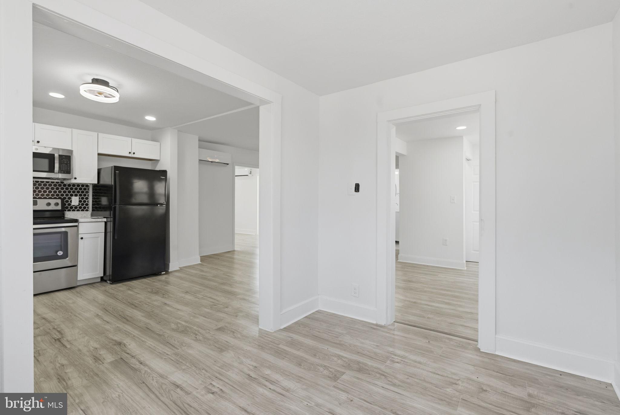 5020 Tucker Hill Road Hague, VA 22469 - Photo 15 of 31 a view of a kitchen with refrigerator stove and wooden floor