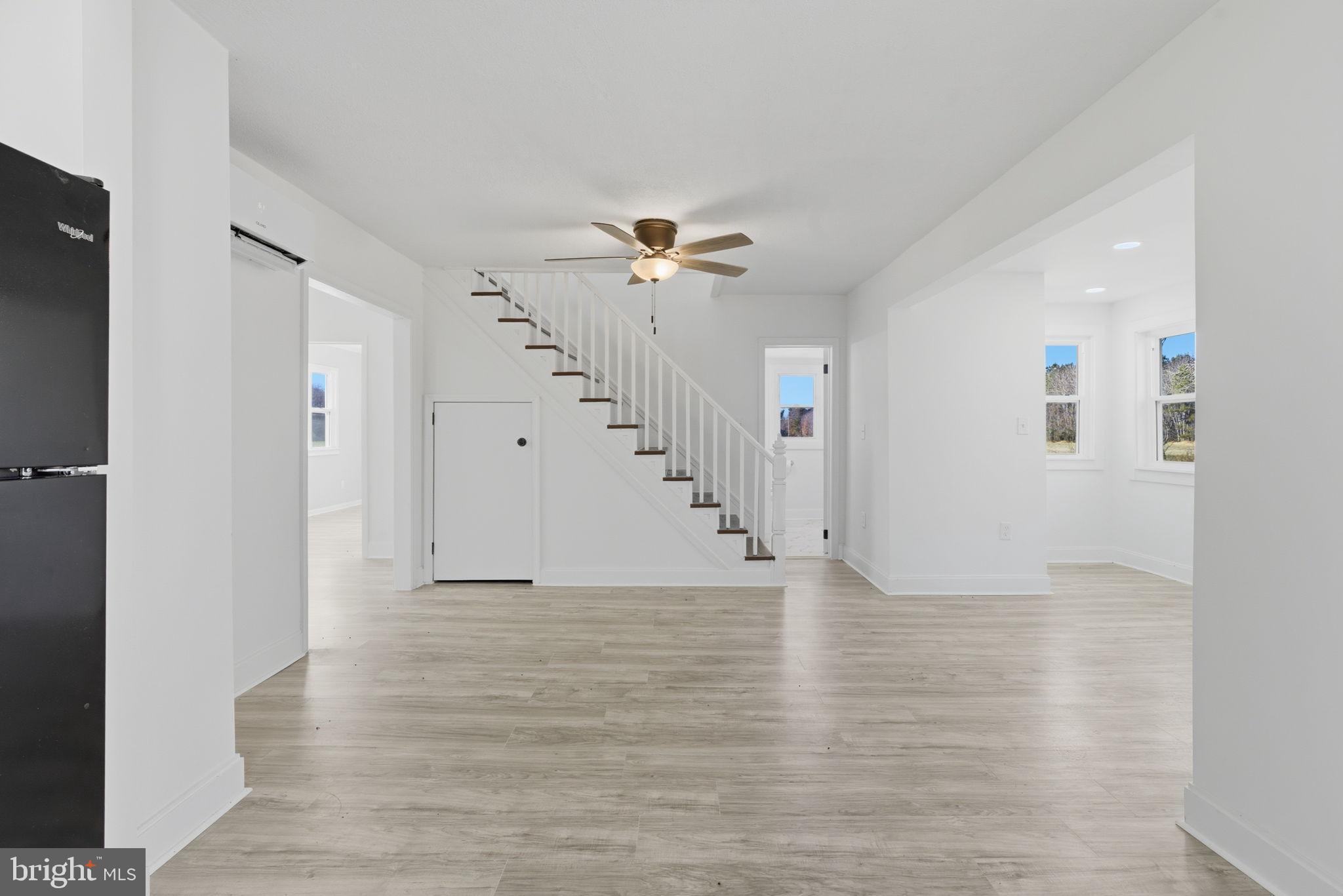5020 Tucker Hill Road Hague, VA 22469 - Photo 18 of 31 wooden floor in an empty room with a ceiling fan