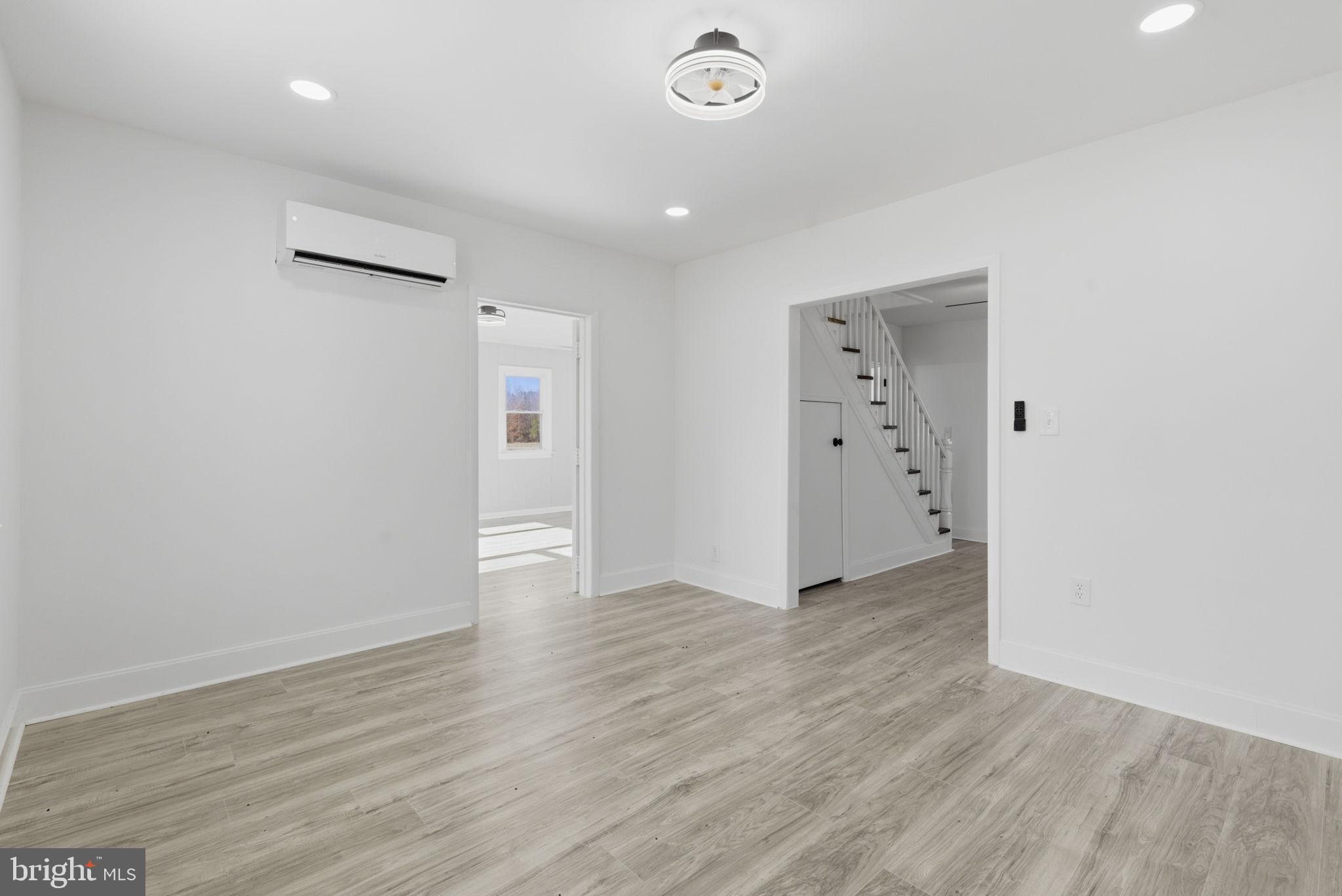 5020 Tucker Hill Road Hague, VA 22469 - Photo 19 of 31 an empty room with wooden floor and white walls