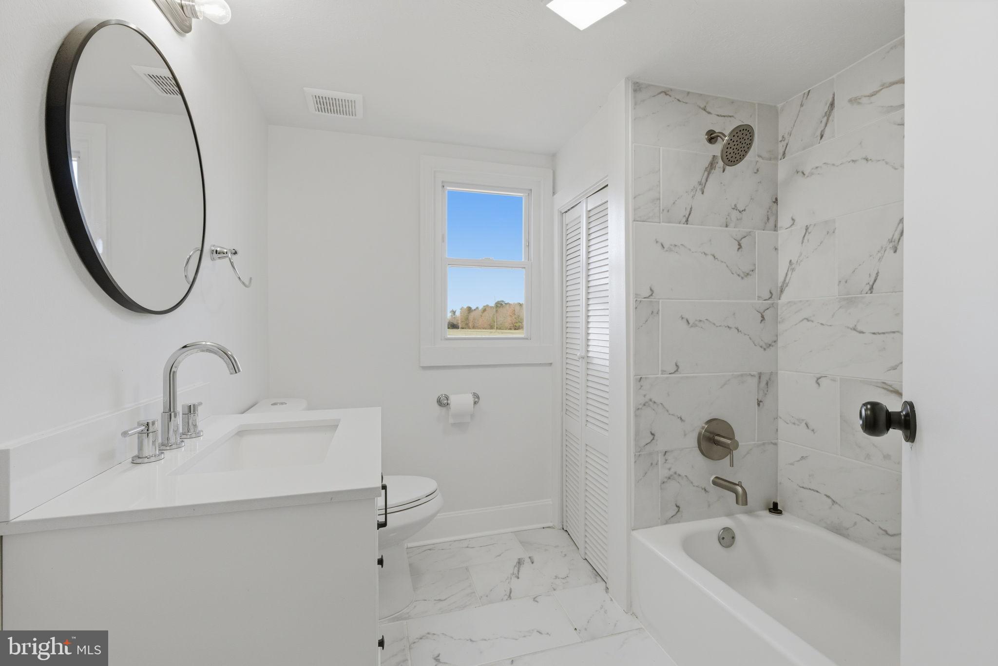 5020 Tucker Hill Road Hague, VA 22469 - Photo 21 of 31 a bathroom with a sink a toilet and a mirror