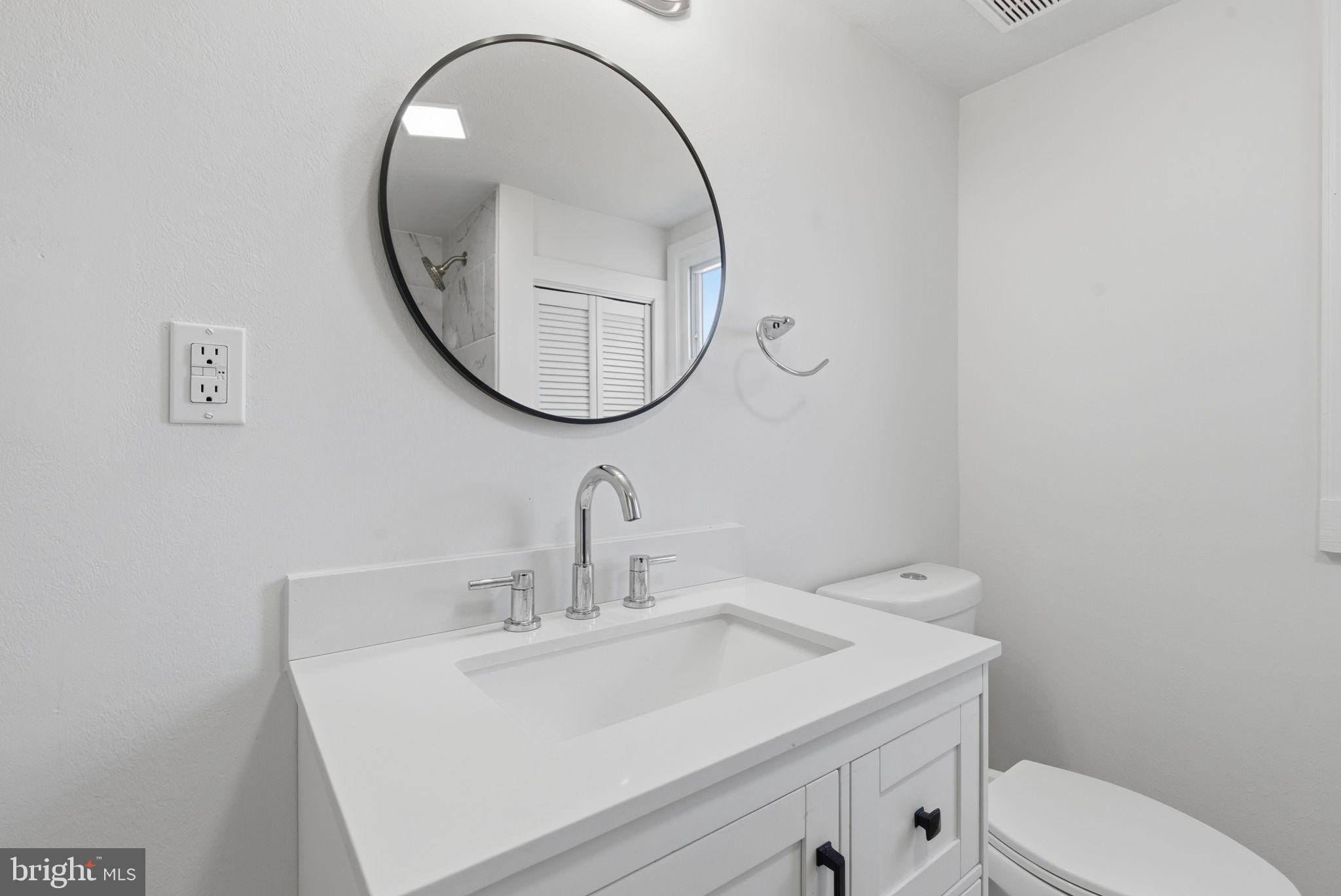 5020 Tucker Hill Road Hague, VA 22469 - Photo 23 of 31 a bathroom with a sink a toilet and a mirror