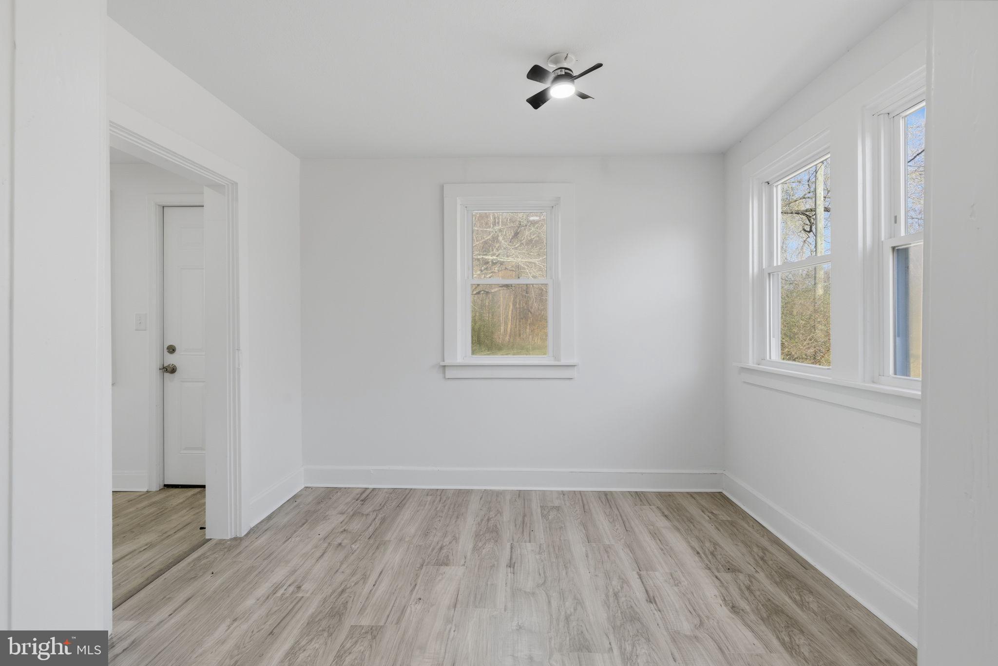 5020 Tucker Hill Road Hague, VA 22469 - Photo 31 of 31 wooden floor in an empty room with a window