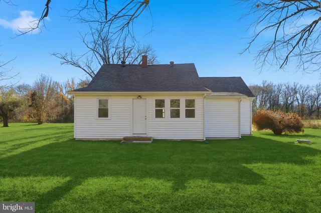 a aerial view of a house next to a yard and trees