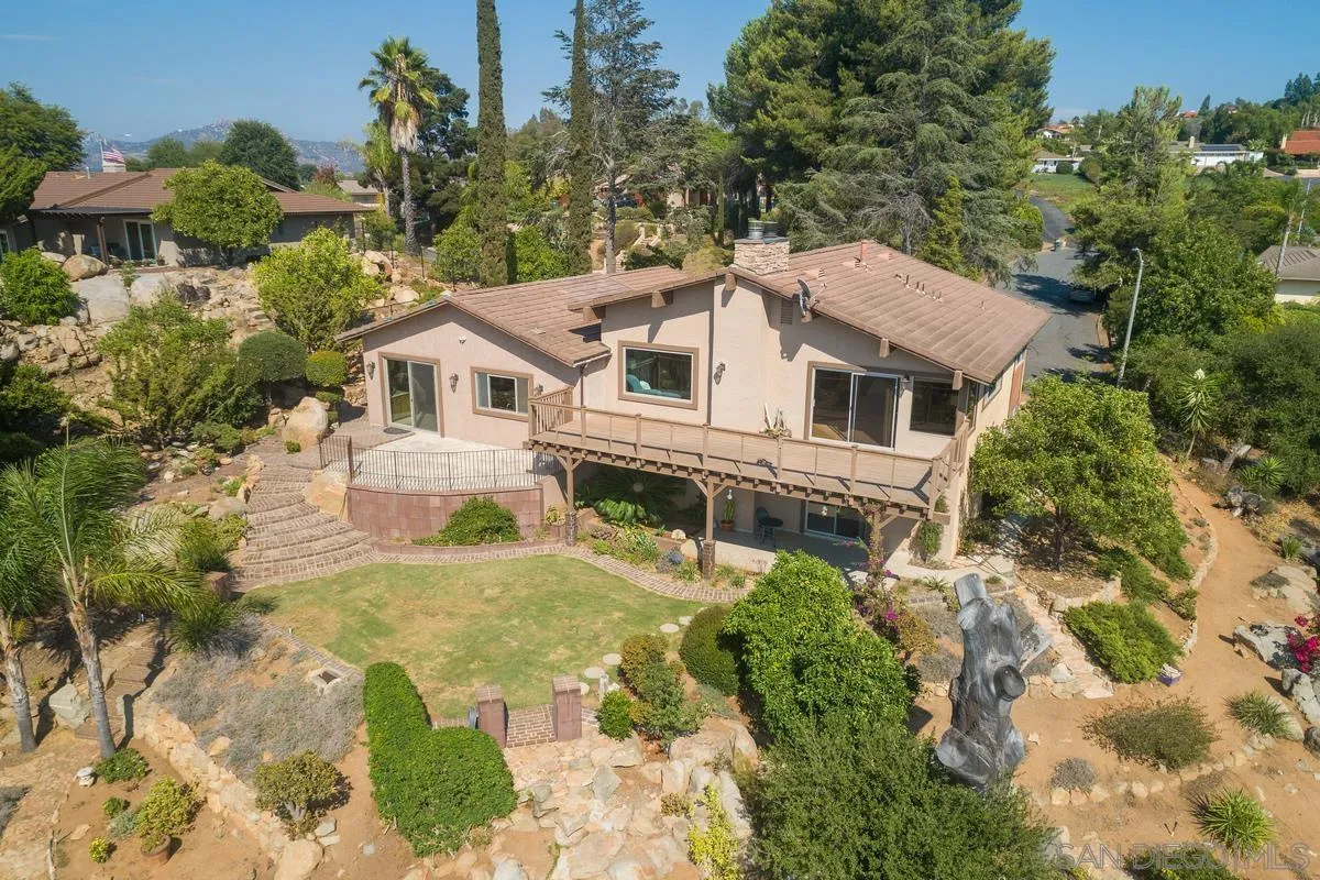 13502 Orchard Gate Road Poway, CA 92064 - Photo 38 of 42 a view of a house with a yard and potted plants