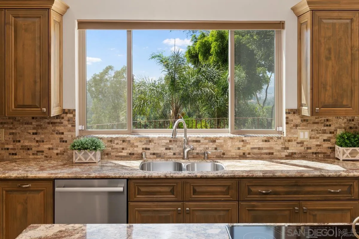 13502 Orchard Gate Road Poway, CA 92064 - Photo 8 of 42 a sink with a granite countertop window and a sink