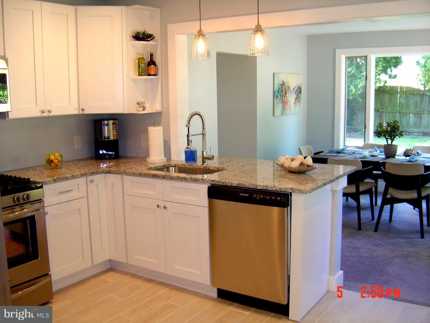 2533 Secane Road Secane, PA 19018 - Photo 3 of 20 a kitchen with stainless steel appliances granite countertop a stove a sink and a microwave