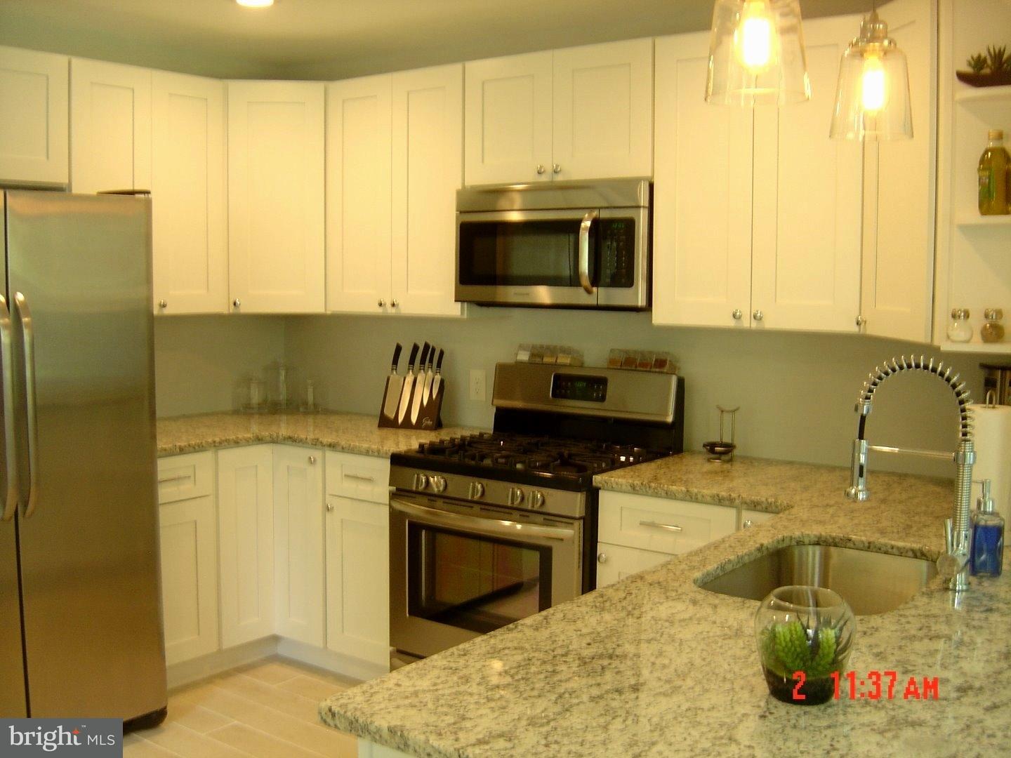 2533 Secane Road Secane, PA 19018 - Photo 4 of 20 a kitchen with a sink a stove and a microwave