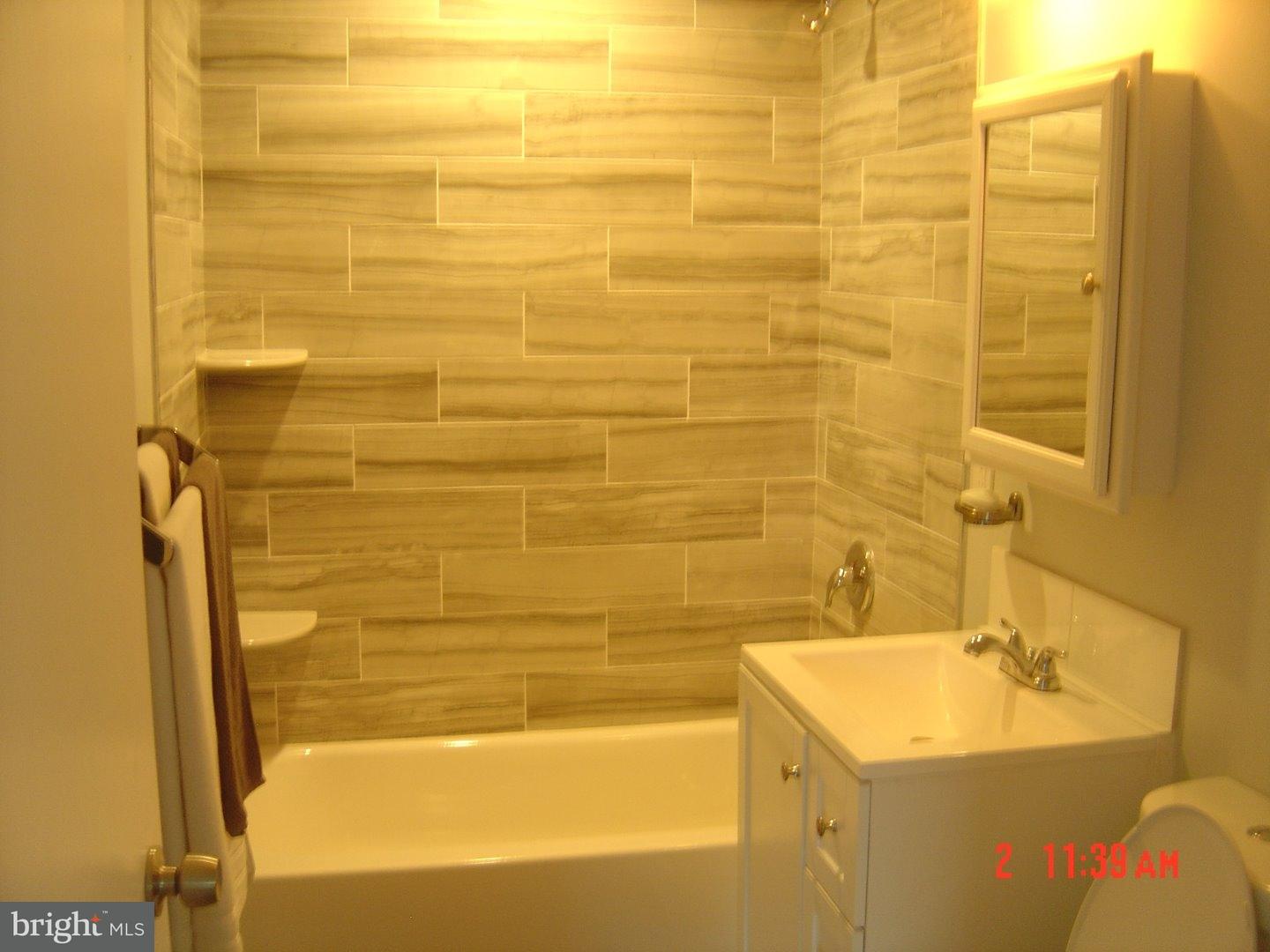 2533 Secane Road Secane, PA 19018 - Photo 9 of 20 a bathroom with a sink mirror toilet and bathtub