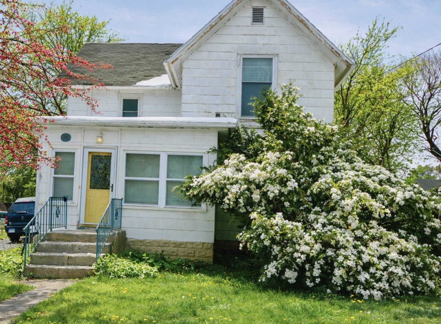 a front view of a house with a garden