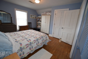 810 Julien Street Belvidere, IL 61008 - Photo 11 of 17 a bedroom with a bed and a closet with wooden floor