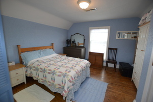 810 Julien Street Belvidere, IL 61008 - Photo 10 of 17 a bedroom with a bed and a dresser with mirror