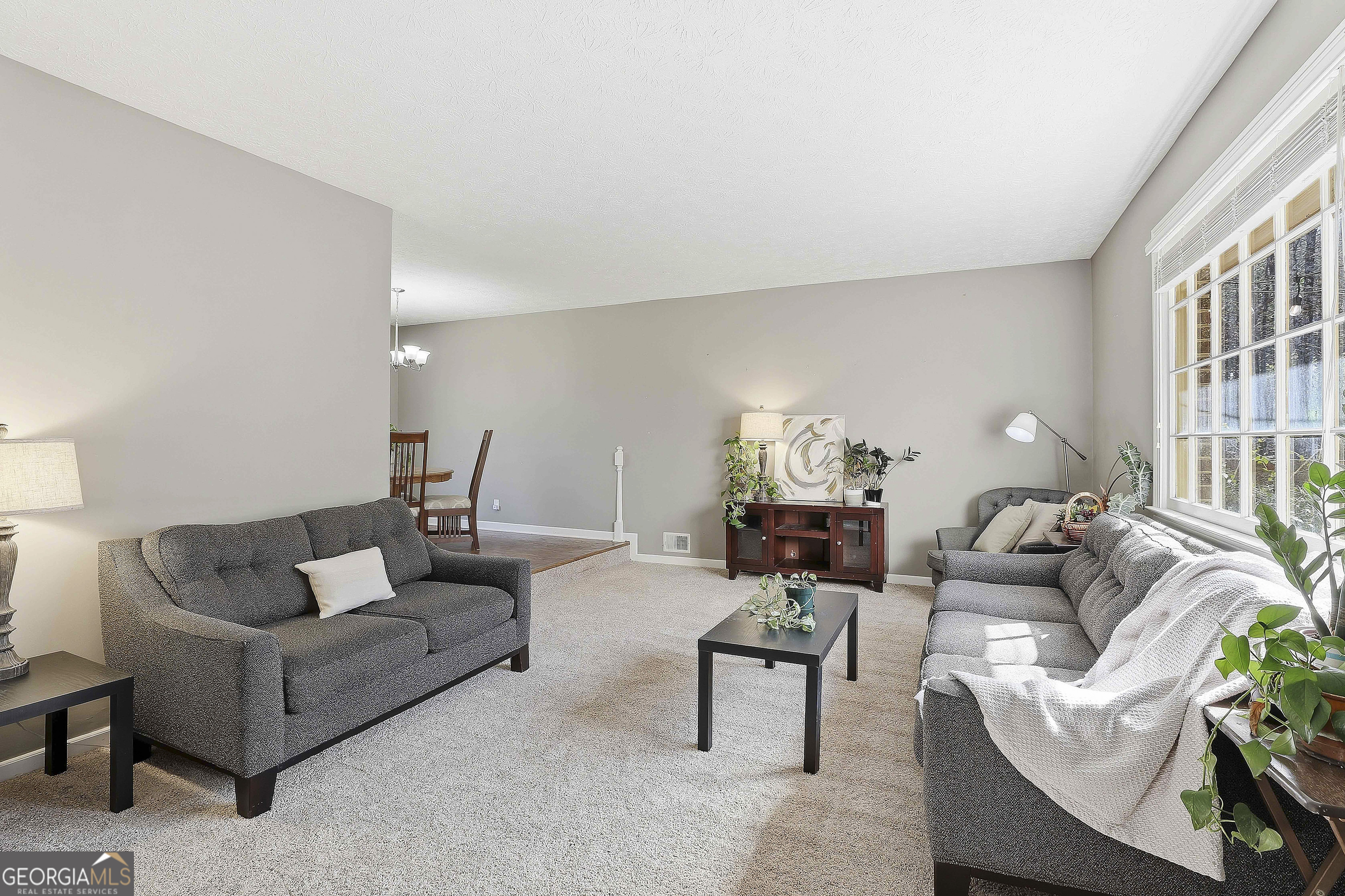 180 Lockwood Road Fayetteville, GA 30215 - Photo 11 of 59 a living room with furniture and a large window