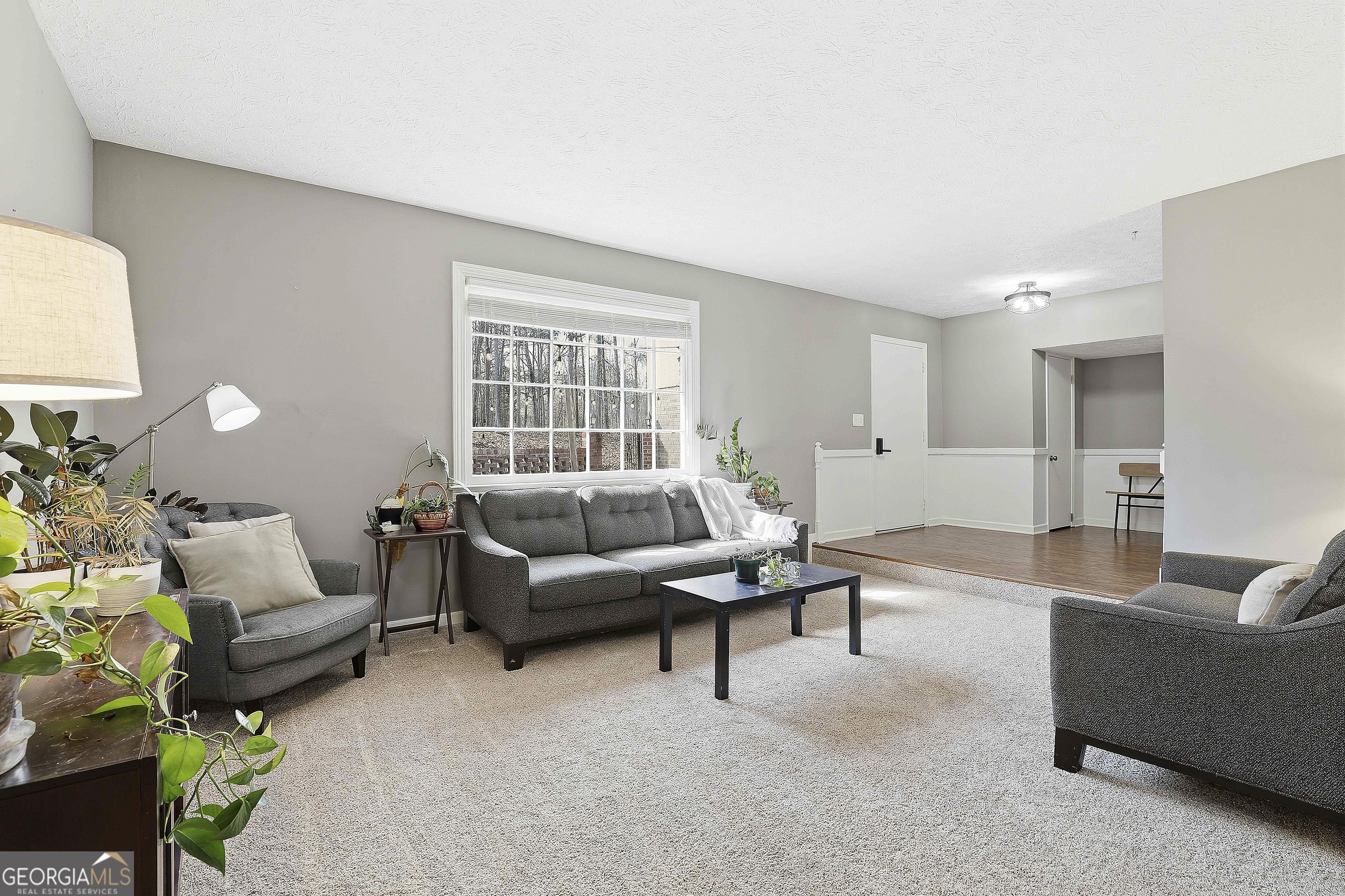 180 Lockwood Road Fayetteville, GA 30215 - Photo 12 of 59 a living room with furniture and a large window