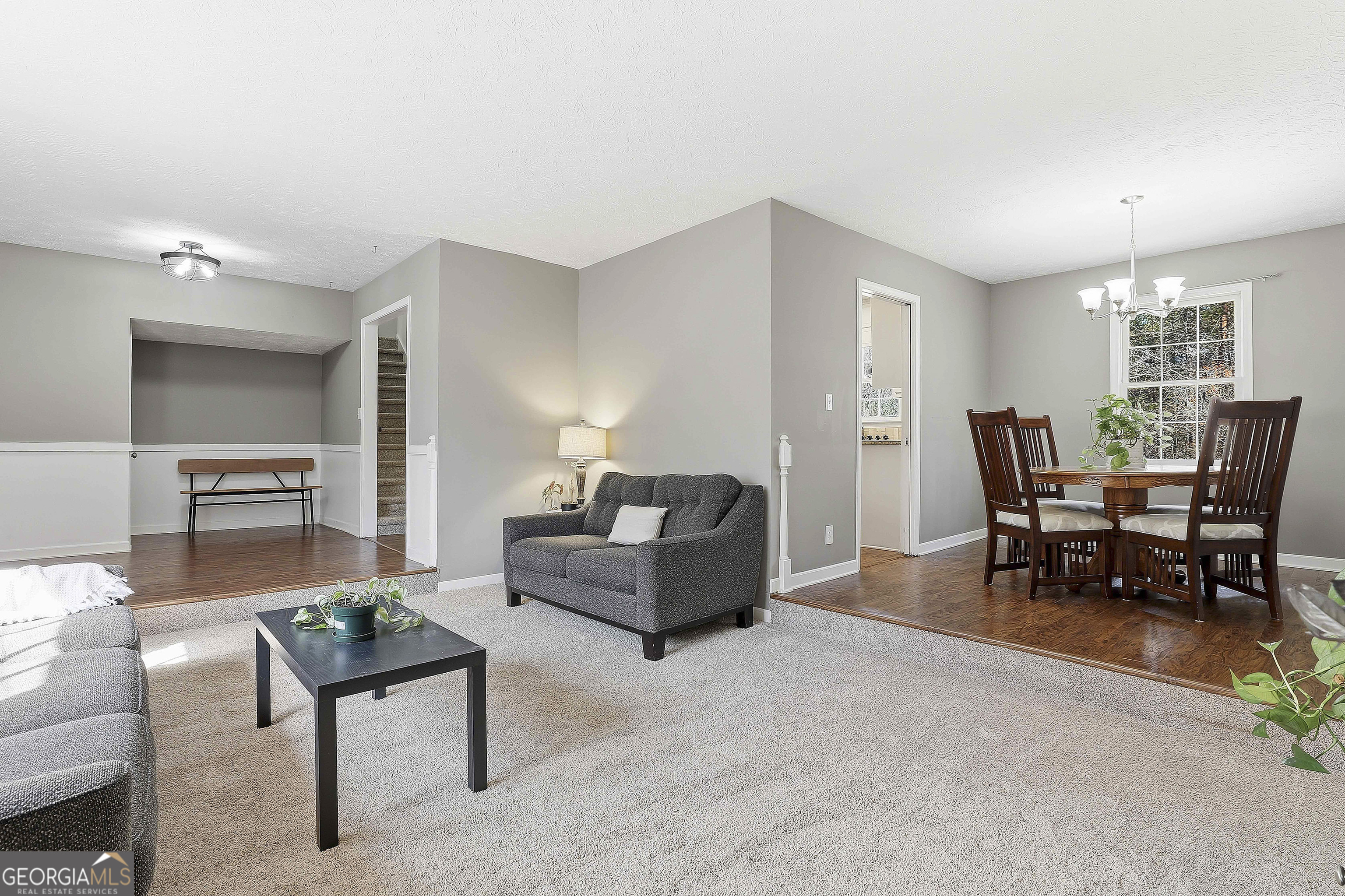 180 Lockwood Road Fayetteville, GA 30215 - Photo 13 of 59 a living room with furniture and a dining table with kitchen appliances