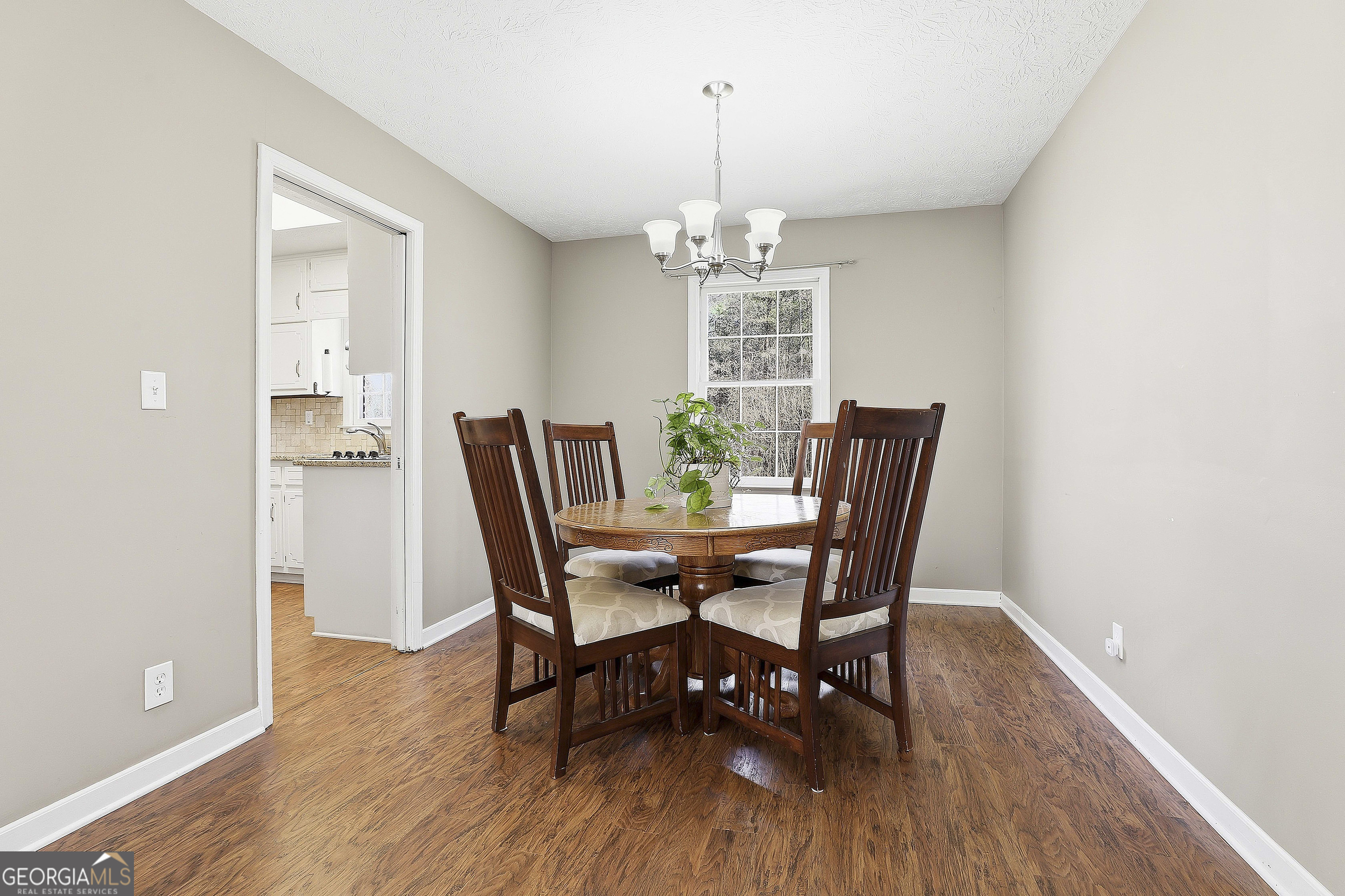 180 Lockwood Road Fayetteville, GA 30215 - Photo 14 of 59 a view of a dining room with furniture wooden floor and chandelier