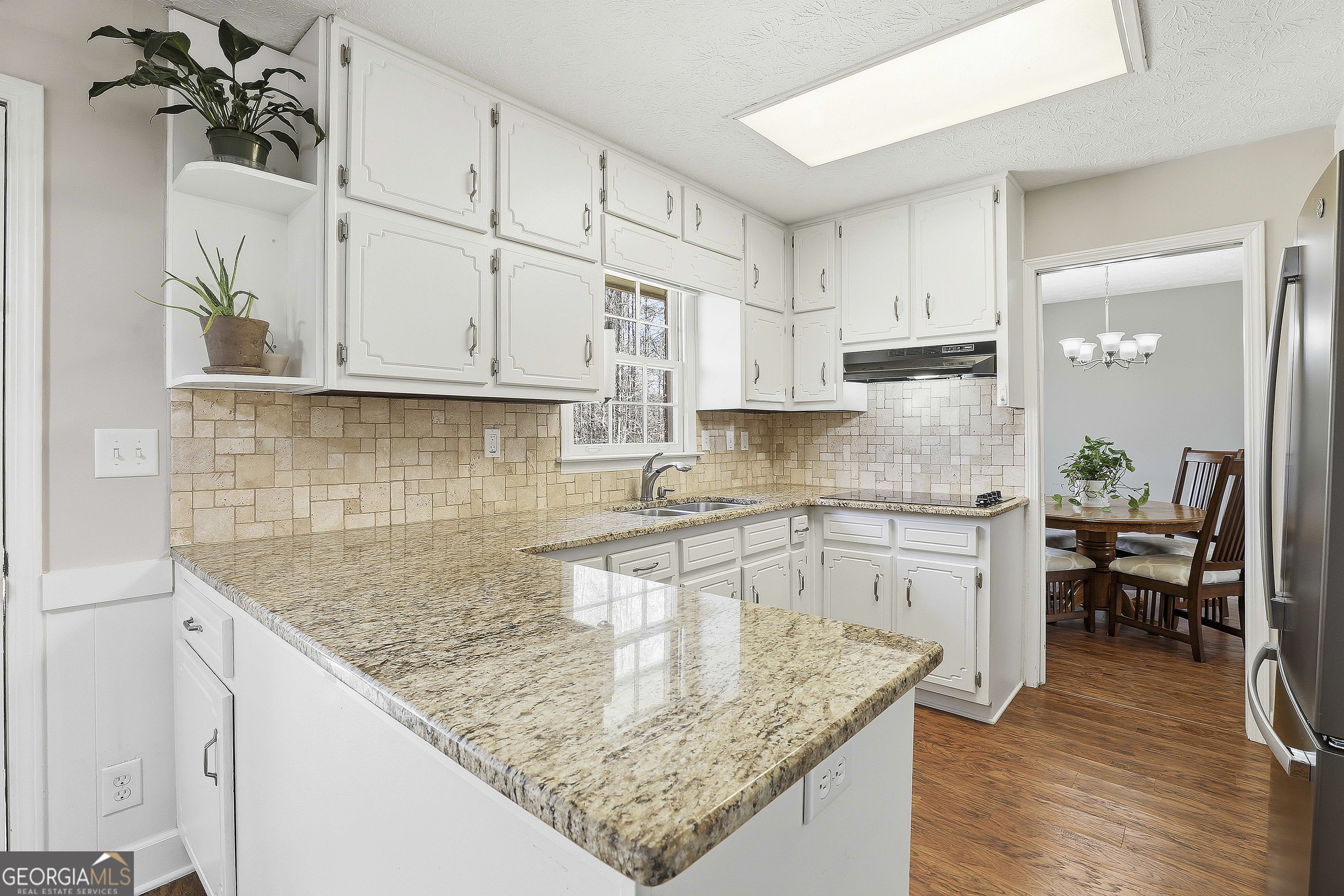 180 Lockwood Road Fayetteville, GA 30215 - Photo 17 of 59 a kitchen with kitchen island granite countertop a sink a counter space appliances and cabinets
