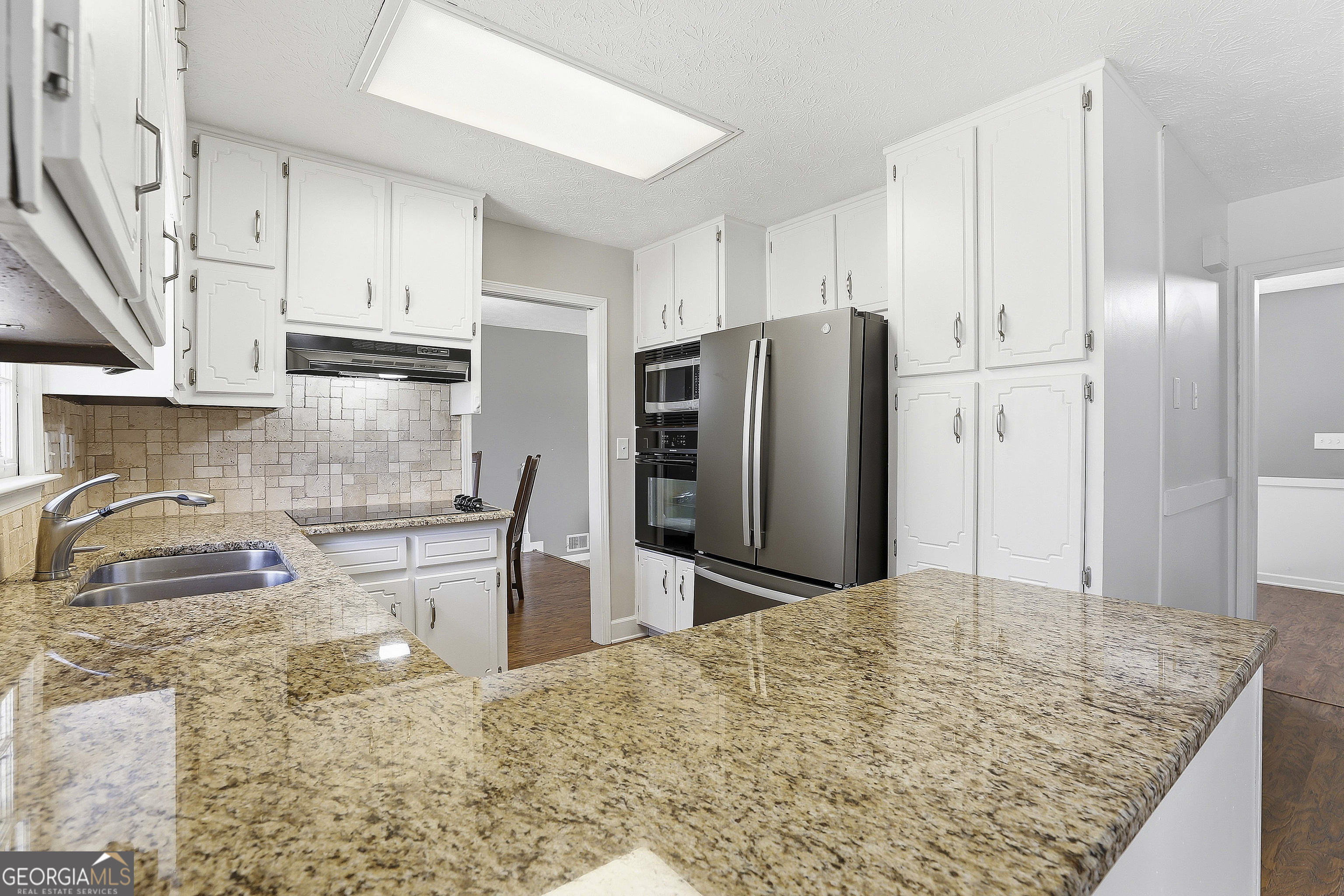 180 Lockwood Road Fayetteville, GA 30215 - Photo 18 of 59 a kitchen with stainless steel appliances granite countertop a refrigerator a stove and a sink