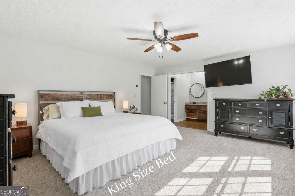 180 Lockwood Road Fayetteville, GA 30215 - Photo 28 of 59 a bedroom with a bed and a television