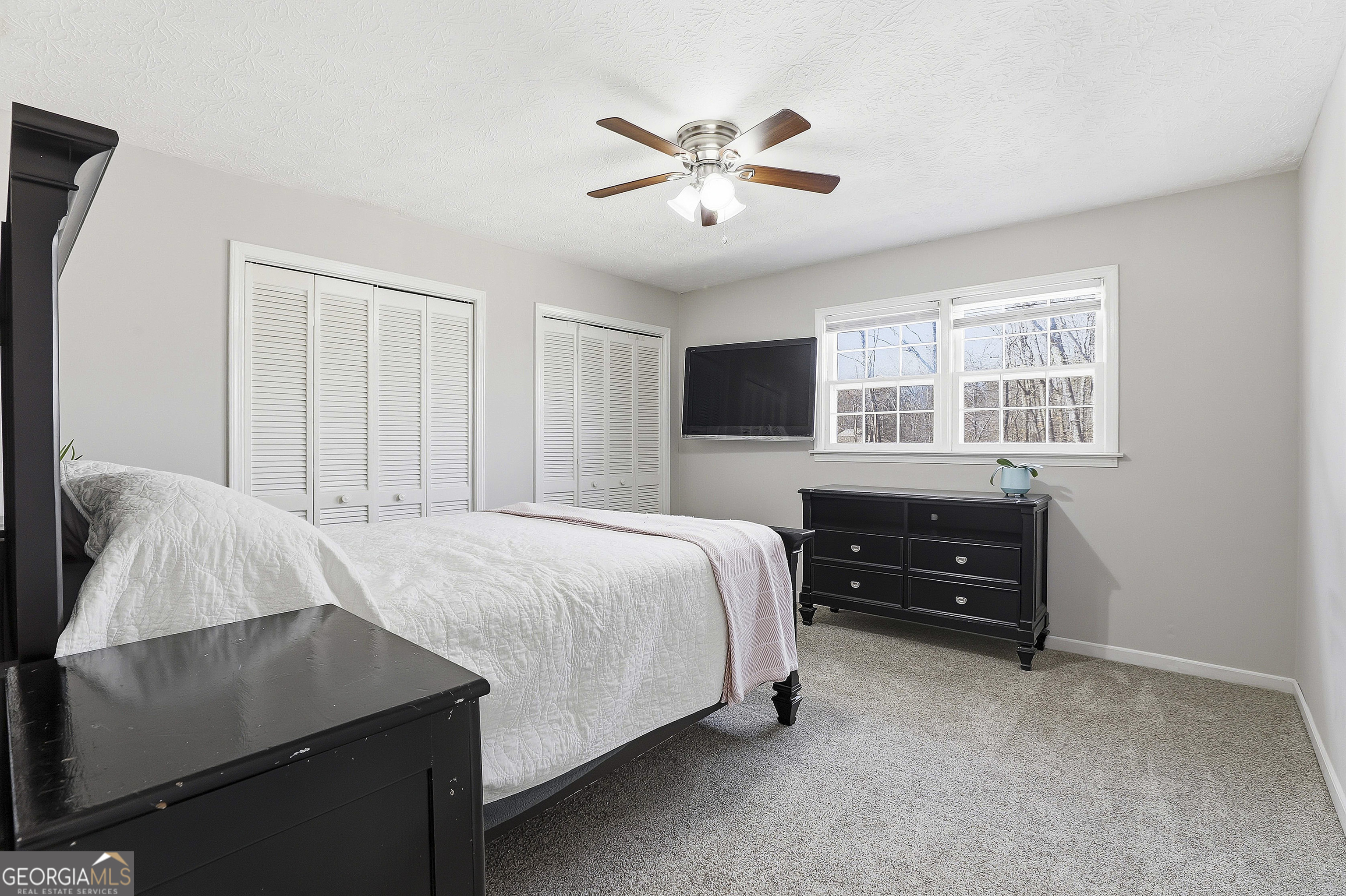 180 Lockwood Road Fayetteville, GA 30215 - Photo 35 of 59 a bedroom with a bed and window