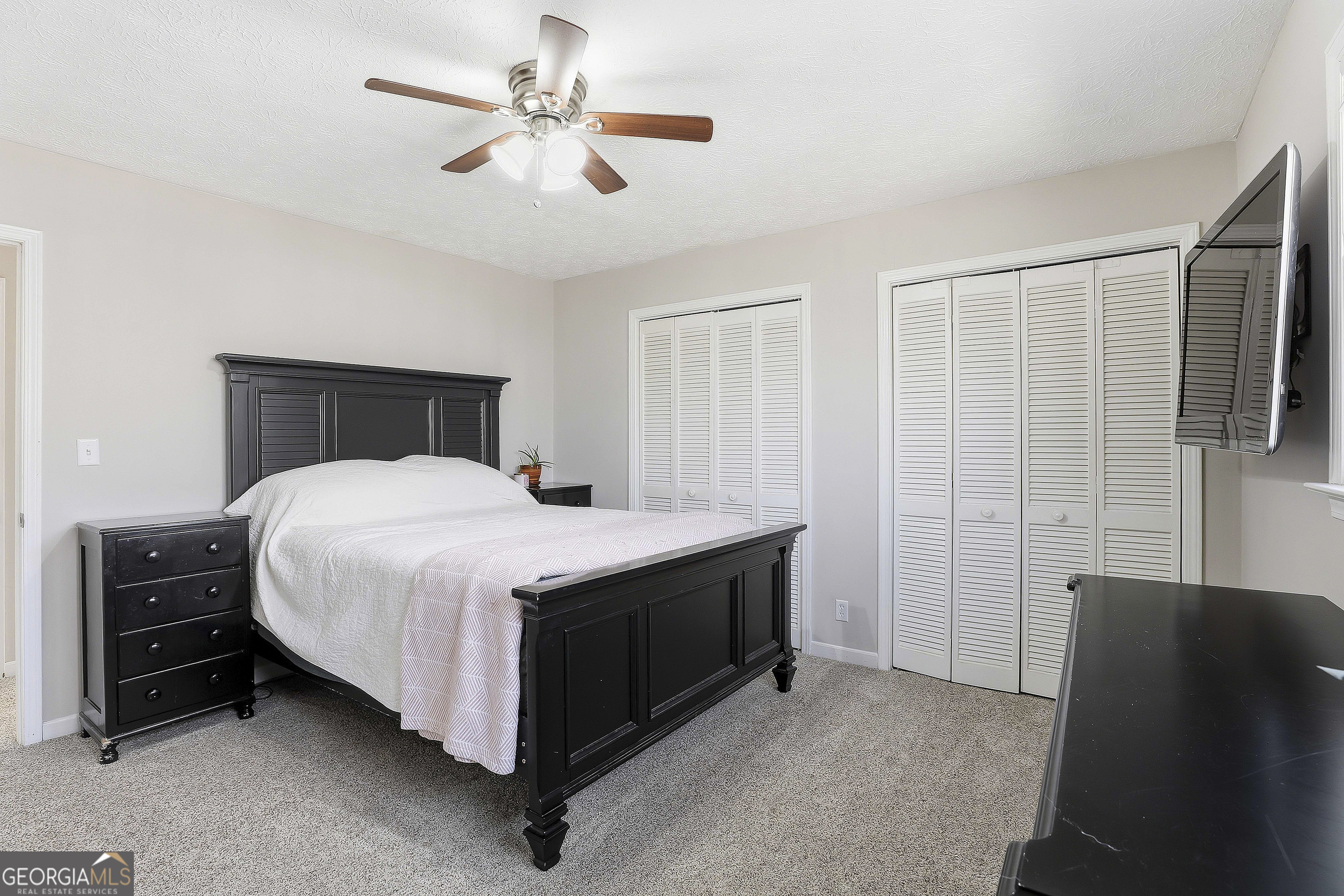 180 Lockwood Road Fayetteville, GA 30215 - Photo 36 of 59 a bedroom with a bed and a chandelier