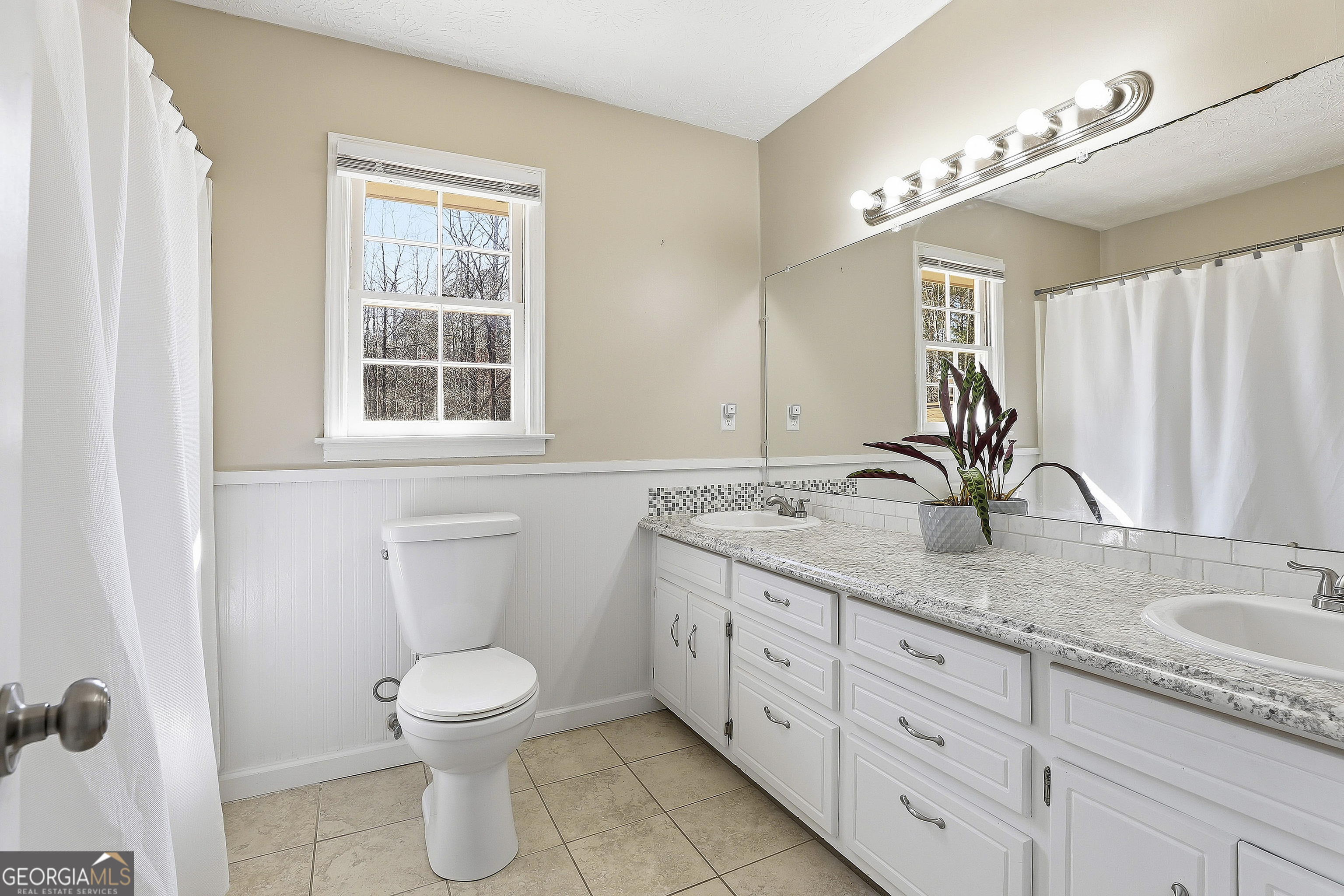 180 Lockwood Road Fayetteville, GA 30215 - Photo 37 of 59 a bathroom with a granite countertop sink toilet and a mirror