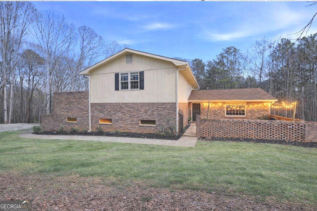 180 Lockwood Road Fayetteville, GA 30215 - Photo 5 of 59 a view of a house with a yard