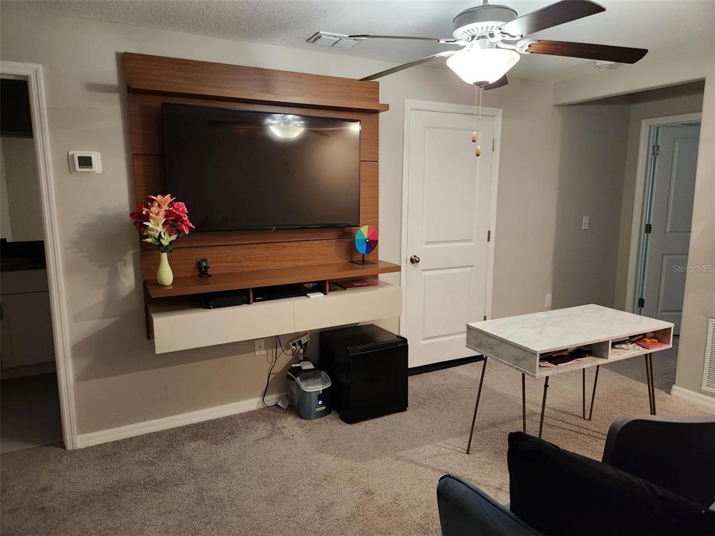 14350 Easy Goer Street Ruskin, FL 33573 - Photo 13 of 23 a room with furniture and a flat screen tv