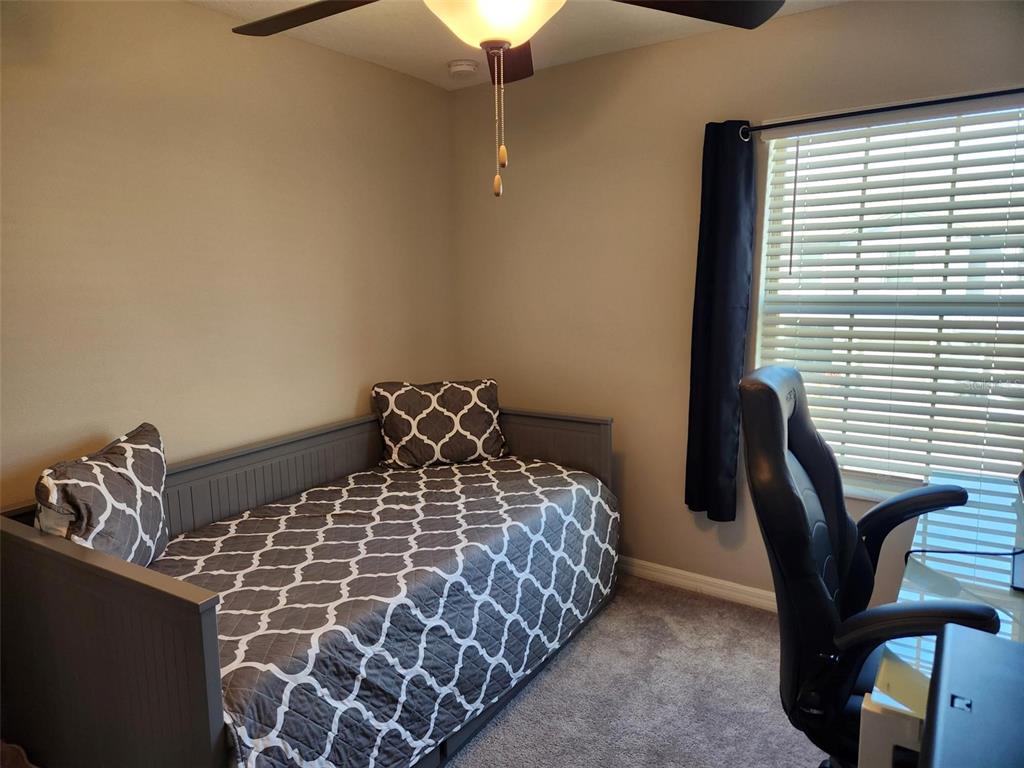14350 Easy Goer Street Ruskin, FL 33573 - Photo 16 of 23 a large bed sitting in a bedroom next to a window