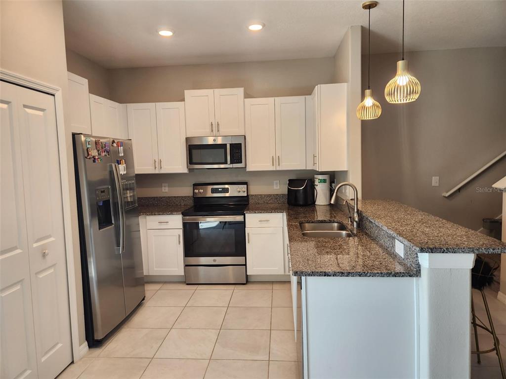 14350 Easy Goer Street Ruskin, FL 33573 - Photo 2 of 23 a kitchen with refrigerator cabinets and microwave