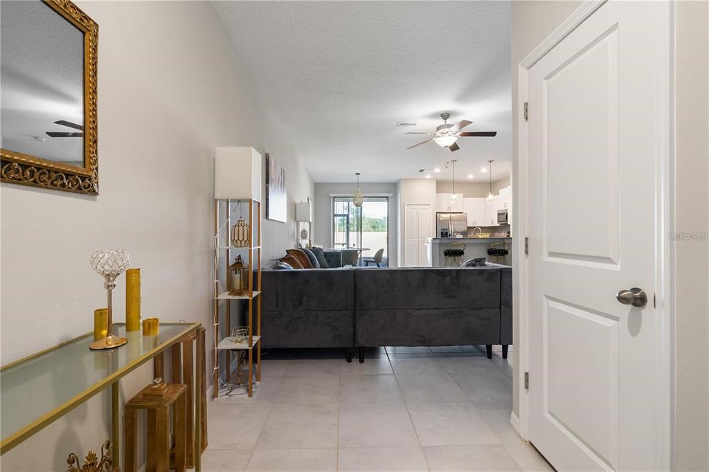 14350 Easy Goer Street Ruskin, FL 33573 - Photo 5 of 23 a living room with furniture and a chandelier