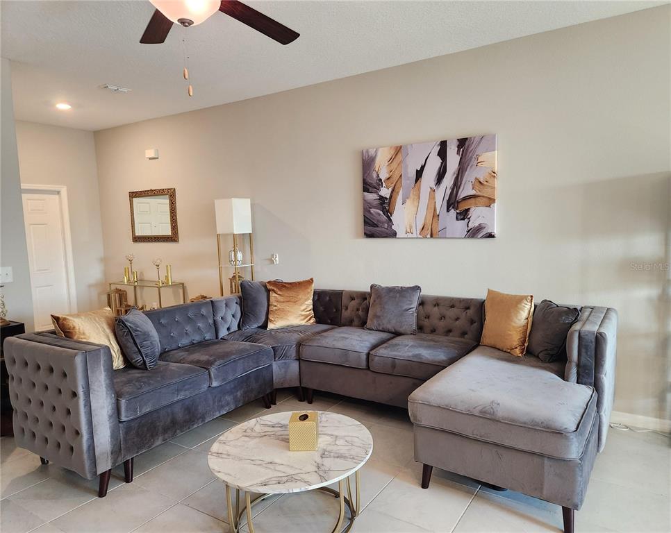 14350 Easy Goer Street Ruskin, FL 33573 - Photo 6 of 23 a living room with furniture and a couch