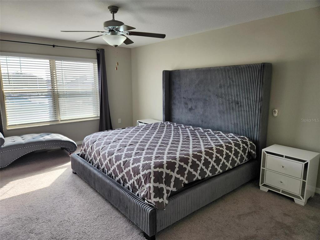 14350 Easy Goer Street Ruskin, FL 33573 - Photo 9 of 23 a bed sitting in a bedroom next to a window