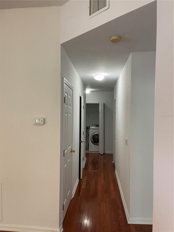 7617 Bayport Road, Unit 57 Orlando, FL 32819 - Photo 16 of 39 a view of a hallway with a hardwood floor
